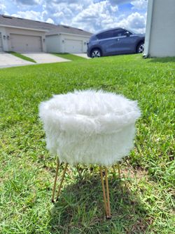 Selling a white faux-leather storage stool.