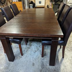 Dark Wood Dining Table And Faux Leather Chairs