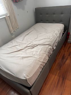 Twin grey upholstered bed
