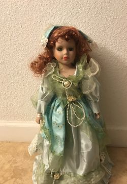 porcelain doll with green dress Vintage porcelain doll with green dress and chair 29769 main image 1