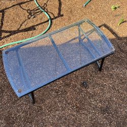 NEGOTIABLE outdoor glass and metal coffee table. 