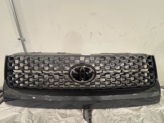 Genuine OEM Toyota Tundra TRD Sport honeycomb grille assembly in dark gray finish.