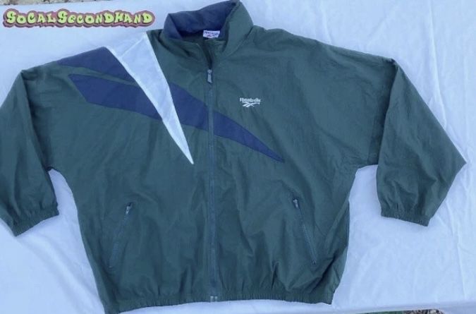 Reebok big shoulder logo full zip nylon jacket with hidden hood mens 2XL white blue ,32” length 29” pit to pit 20” sleeve . Good condition. Only worn