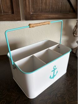 white and teal farmhouse utensil caddy featuring a nautical anchor design and a rope-wrapped metal handle