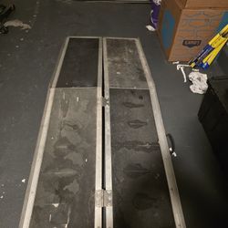 Heavy-duty folding aluminum loading ramp designed for mobility scooters, wheelchairs, or small equipment.