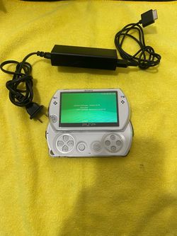 White sony psp go with charger and case
