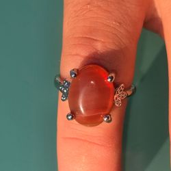 Orange gemstone ring with butterfly design