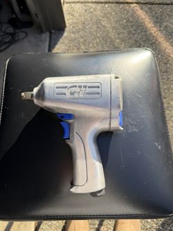 Used pneumatic impact wrench (air impact gun) in working condition. Shows normal wear from use but appears solid, with no visible damage to the housin