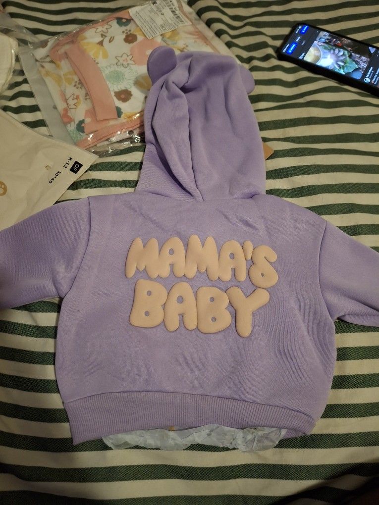 Newborn Clothes And A Bottle Warmer