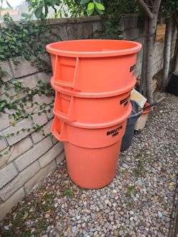 Fifty five gallon orange brute trash cans