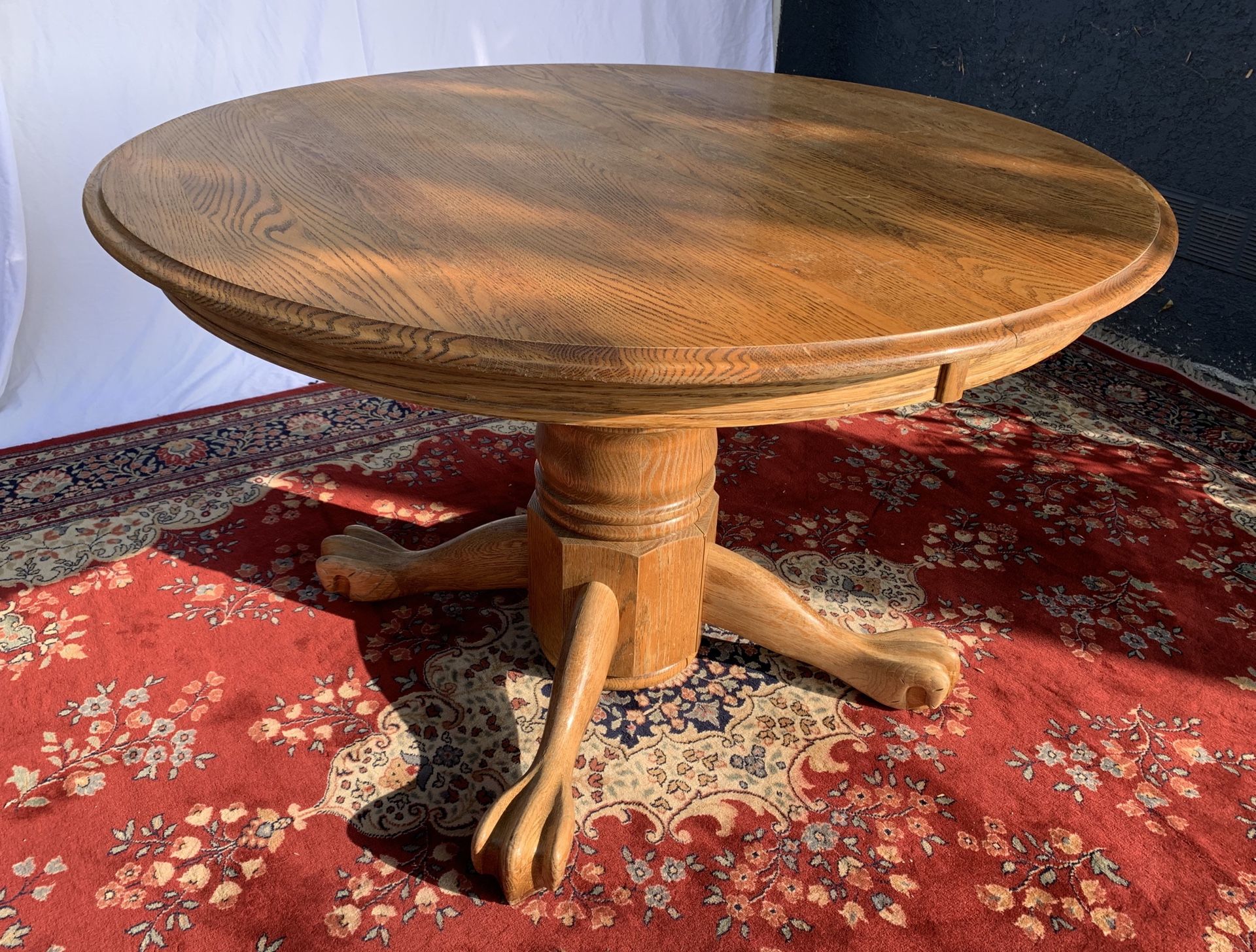 Round solid oak “claw foot” kitchen table with removable leaf