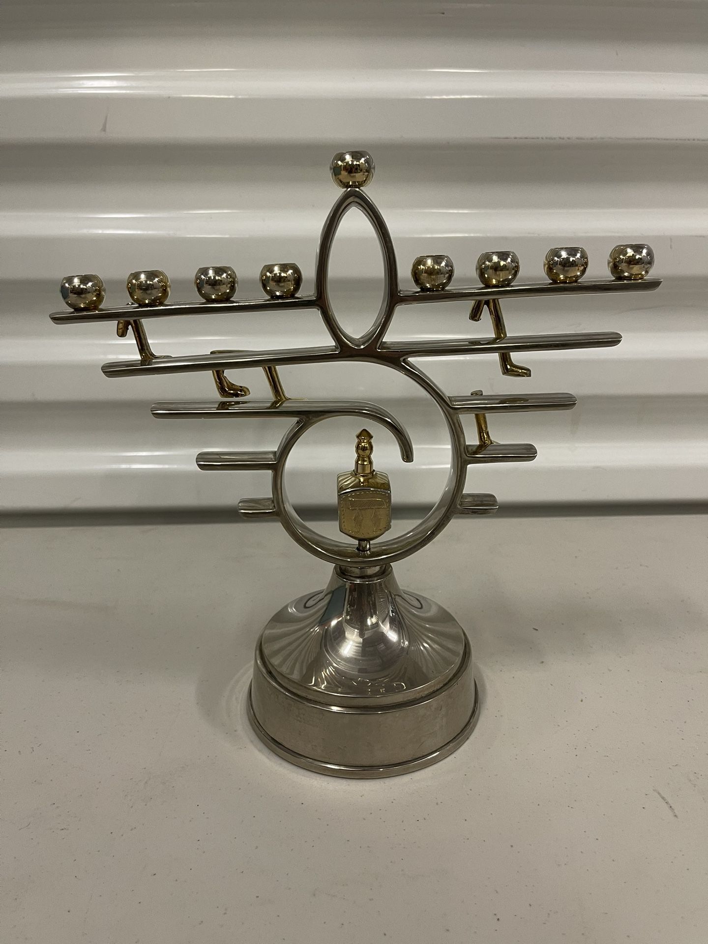 This is a vintage gold and silver plate menorah