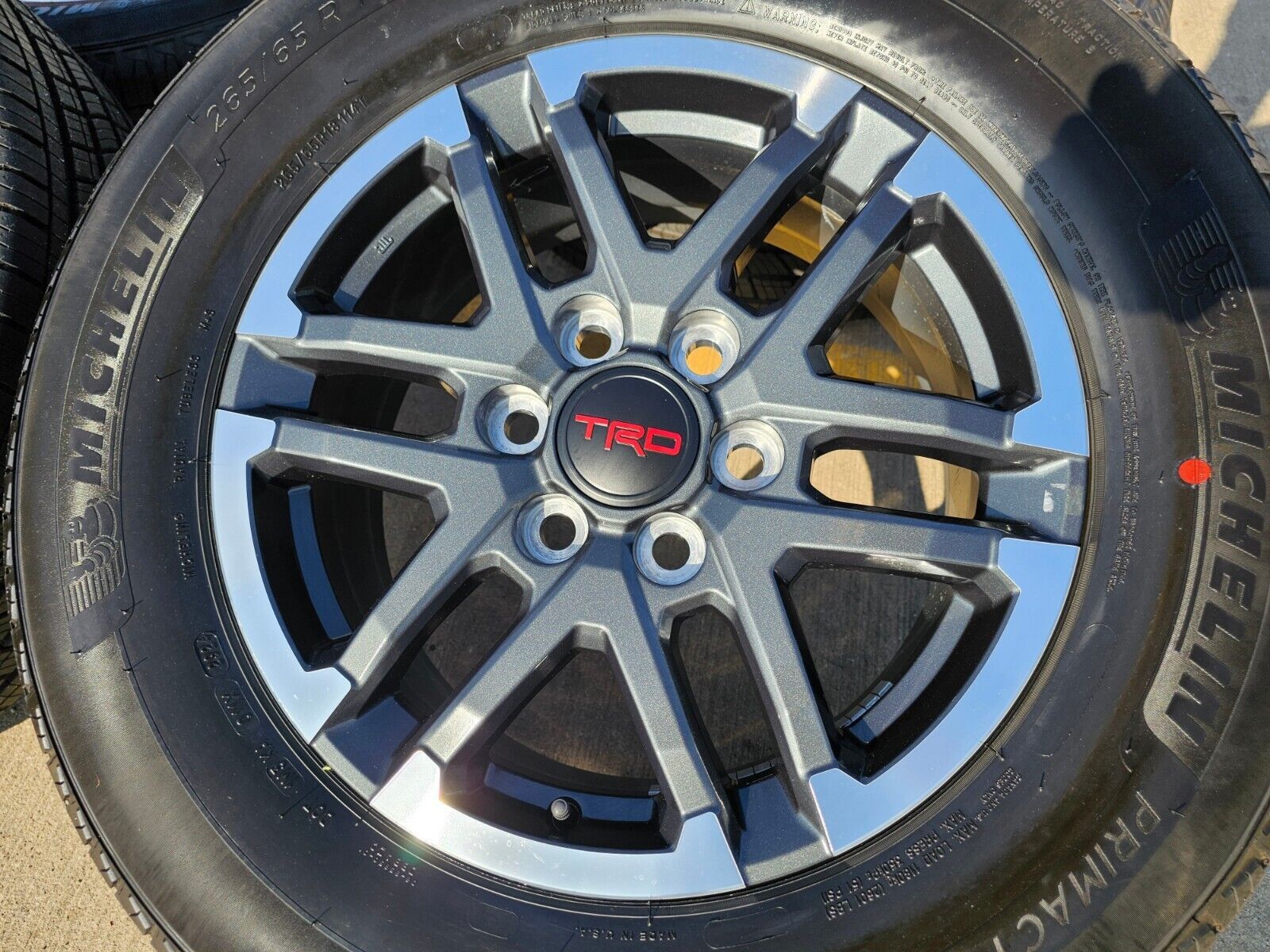 Set of (4) new 18" 2025 TRD Sport wheels with original Michelin 265 65 18 tires