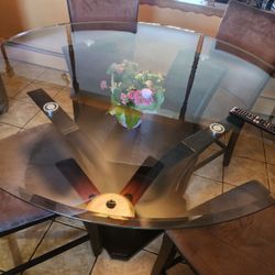 Glass Table With 4  Brown Chairs 400.00