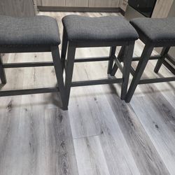 3 MATCHING DARK GREY  SADDLE STYLE STYLE BAR STOOLS  $100  OBO.