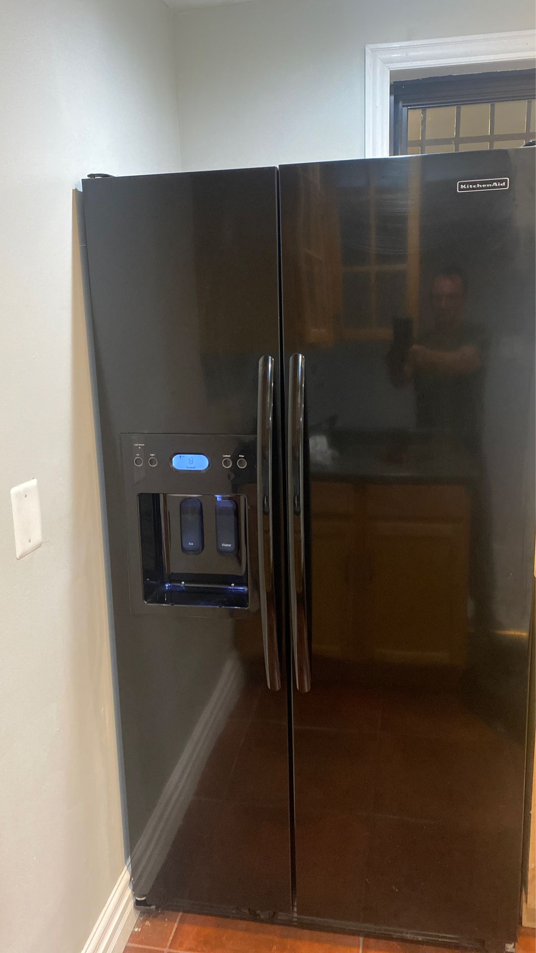 KitchenAid black refrigerator with ice and water dispenser