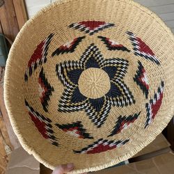 This is a Navajo ceremonial basket, a traditional Native American coiled basket