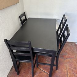 black kitchen table with four chairs