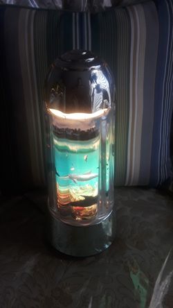 A desktop lamp that haves fish swerving around