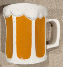 The Coffee Mug 3D Foamy Beer Yellow Novelty Mug by Tag is a unique and fun addition to any kitchen or living space. With a round shape and 3D raised f