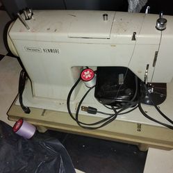 Vintage sewing machine with foot pedal and case