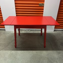 Antique table  with side extensions .