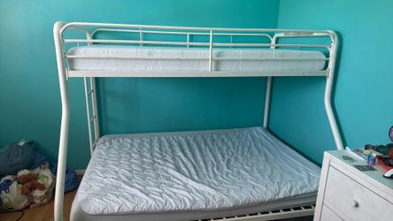 White metal bunk bed including top mattress