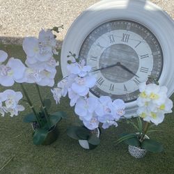 Wall Clock And Fake Flower Arrangements 