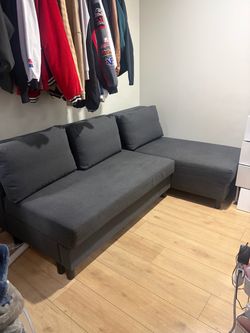 Grey pull out couch with storage