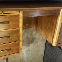 Oak desk vintage. Drawers have dovetailed craftsmanship. Very good condition  58” x 29” x  30”   6 drawers Office chair included. 