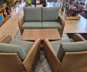 New resin wicker outdoor patio set. Two seat couch with two oversized chairs with cushions and table.