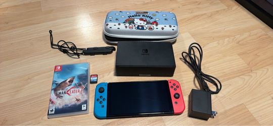 Nintendo switch oled with docking station, charging cord, case, wrist straps and Nintendo switch sports and Maneater games. No trades cash only see my