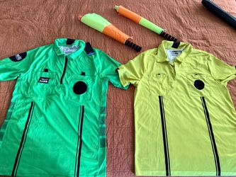 Set of 2 soccer referee jerseys in bright green and neon yellow, plus 2 assistant referee flags.