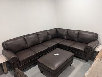 Brown leather sectional + ottoman