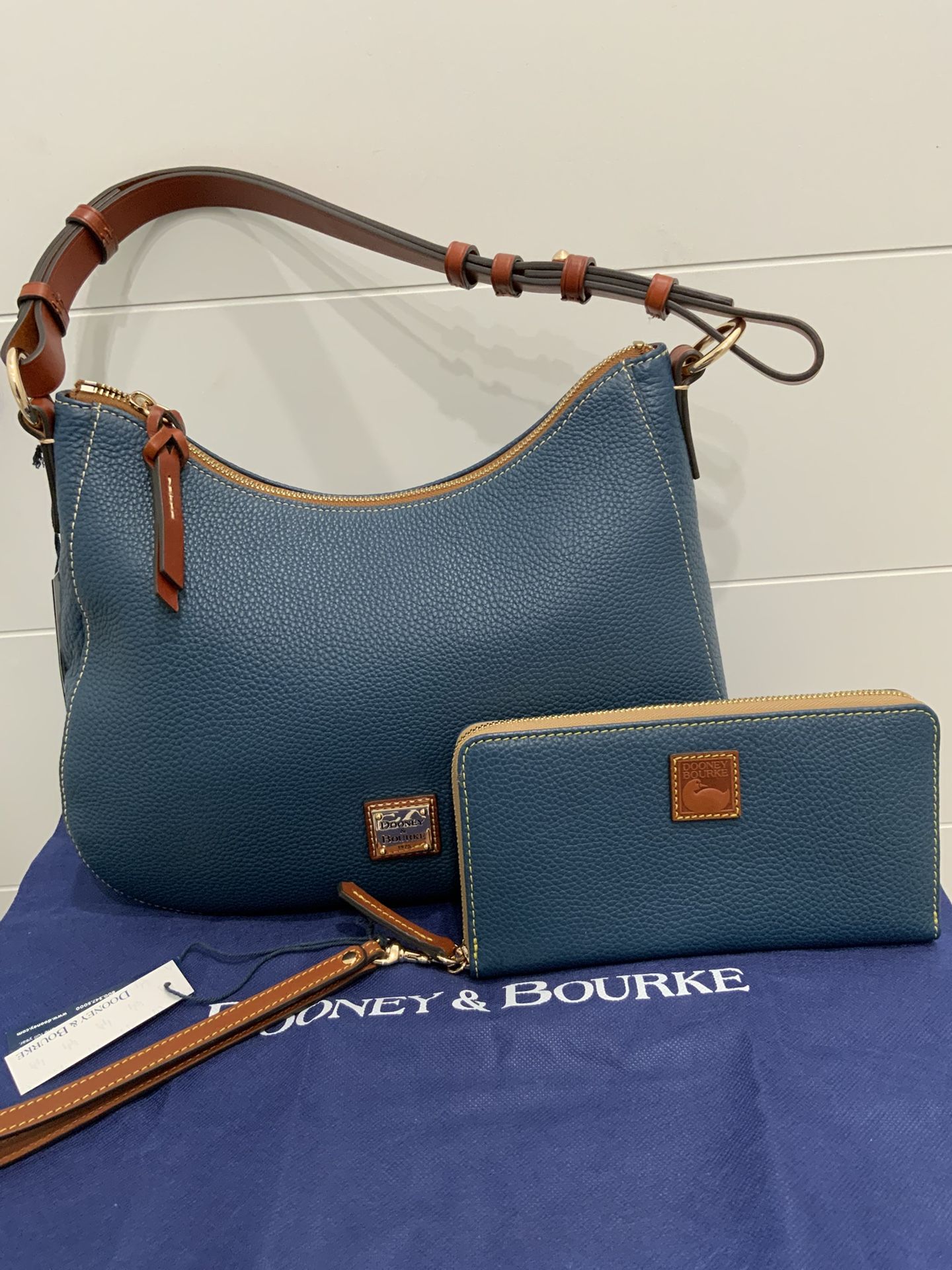 Authentic Dooney & Bourke Pebble Grain Shoulder Bag with matching wallet. Color is Jeans. Zipper closure.