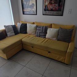 Sectional Sofa from Ikea.
FRIHETEN
3 seat w/storage, Faringe light gray with a yellow cover on it.