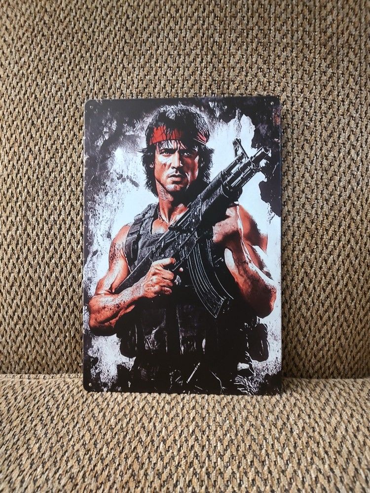 RAMBO METAL SIGN.  12" X 8".  NEW.  PICKUP ONLY.