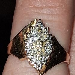 The item is a 10K yellow gold ladies diamond cluster ring. This ring features multiple diamonds arranged in a cluster design 
