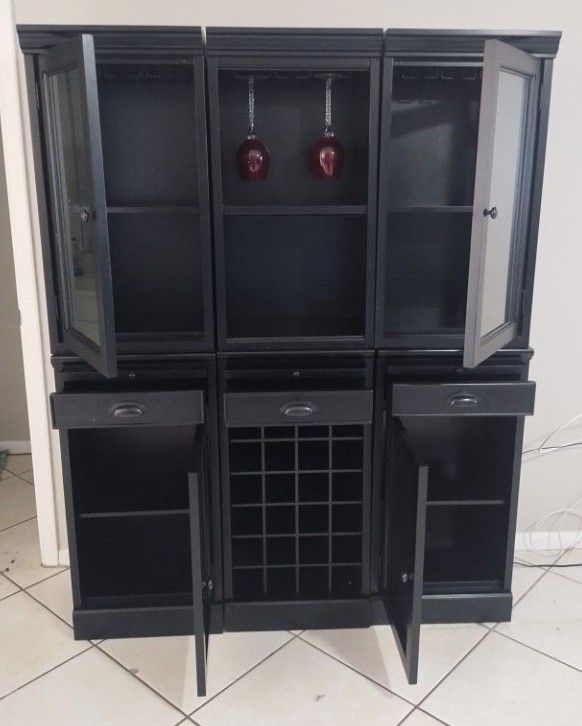 Beautiful Black wood cabinet fully adaptable to your spaces. It has 6 individual compartments, space to put glasses, wine, and decoration.