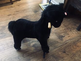 Rolling Black and White lifelike Horse for small child.