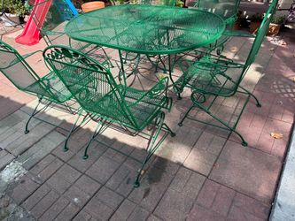 Iron patio table with 6 rocking chairs
