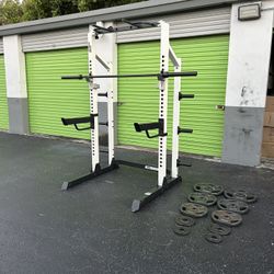 Half rack heavy duty with 225lbs of Olympic weights plus barbell hole gym pull up bar dip bar squat 