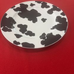 The product is a  222 Fifth cowhide large dinner plate in a farmhouse cow print design. This round plate have a diameter of 12.5 inches and is made of