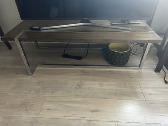 Modern brown wood sofa table with silver metal frame.