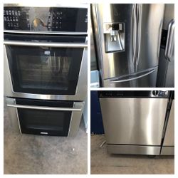 Stainless steel French door kitchen appliance set.