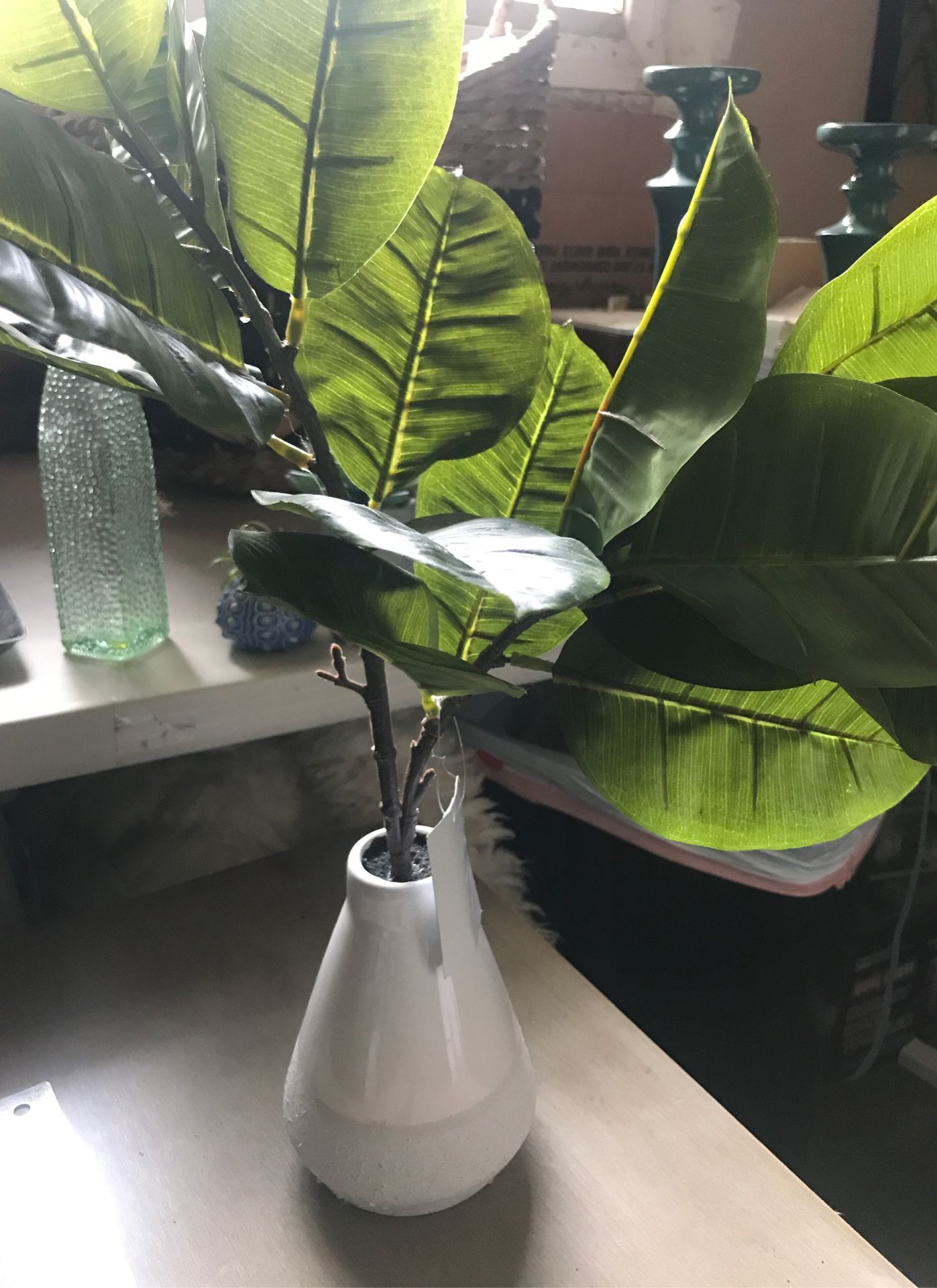 Faux green plant in ceramic vase