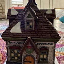 Dept. 56 Heritage Village Collection – Dickens’ Village Series “WM. WHEAT CAKES & PUDDINGS” – 1993 Hand-painted porcelain. Includes original box, Styr