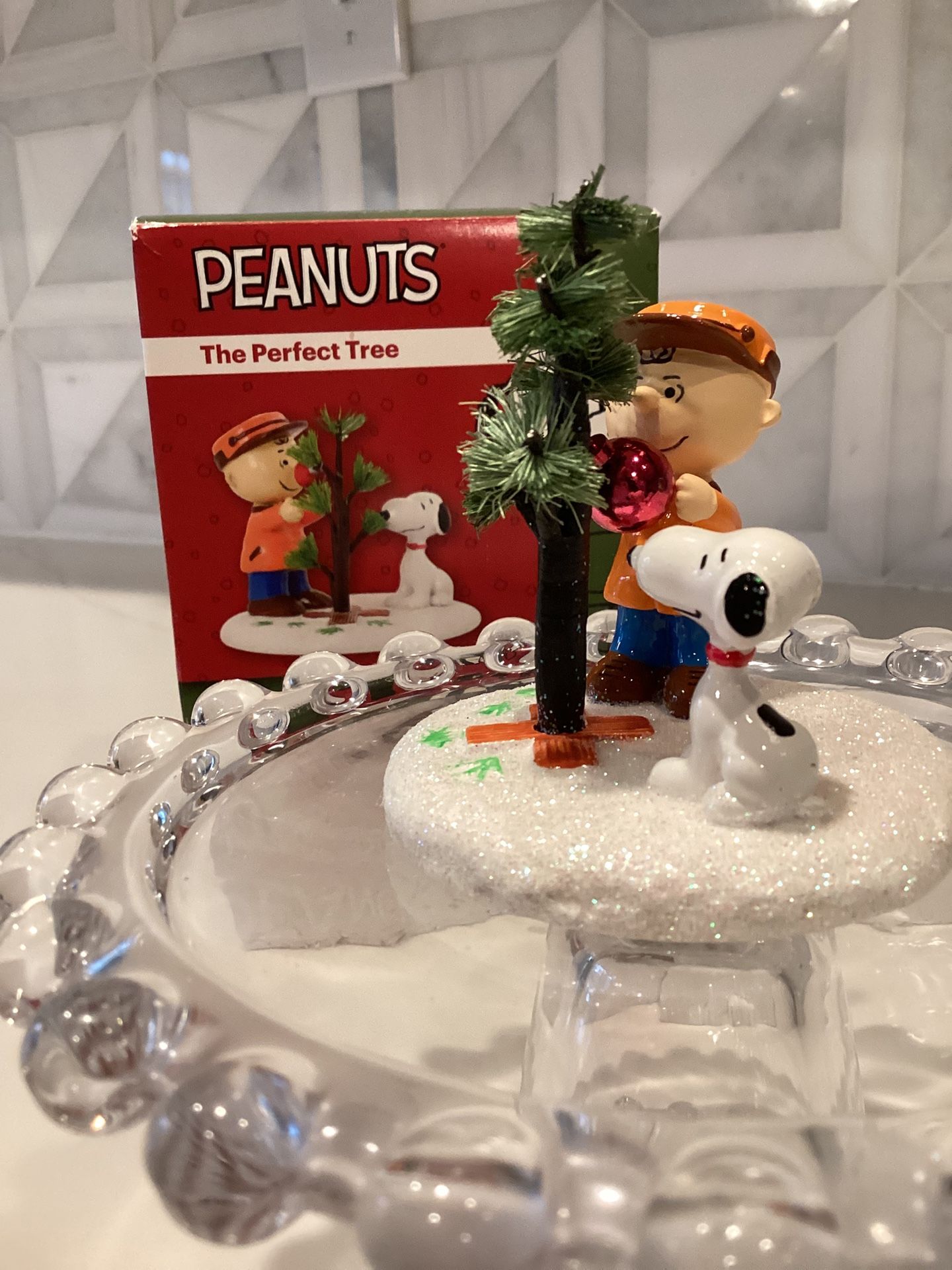 Peanuts figurine featuring a character with a tree and Snoopy. Department 56 2.8”T (new in box)