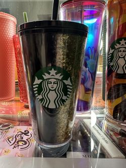 Small, black and gold Starbucks cup