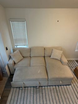 Beige Sectional Sofa with Ottoman and Pillows